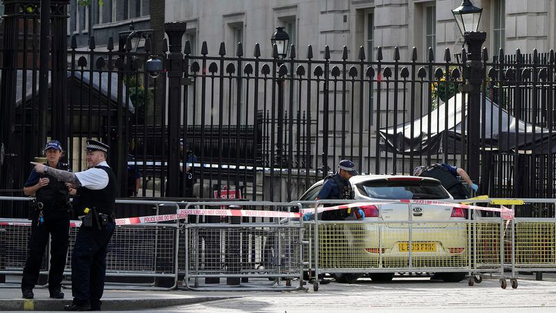 Police at the scene after a car collided with the gates of Downing Street in London in London,...