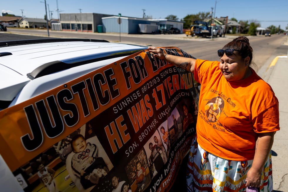 Blossom Old Bull holds up a banner for her son which says "justice for Braven Glenn," during a...