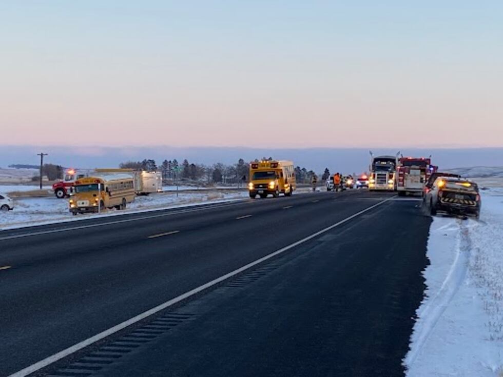 Car collides with school bus on Highway 52