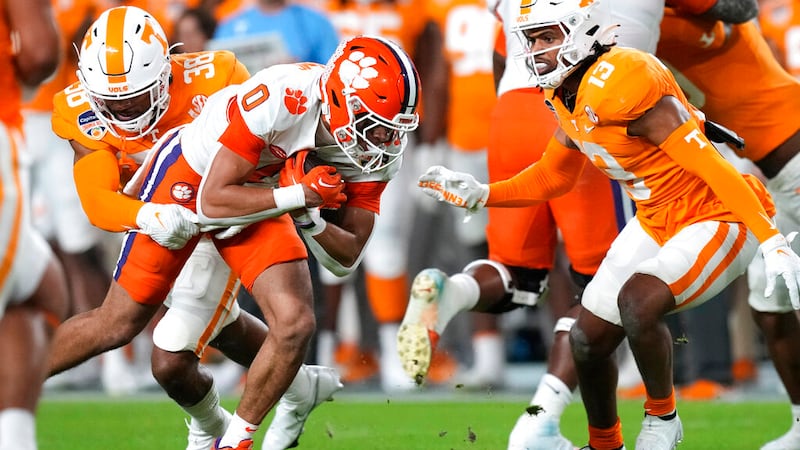Clemson wide receiver Antonio Williams (0) runs as Tennessee linebacker Solon Page III (38)...