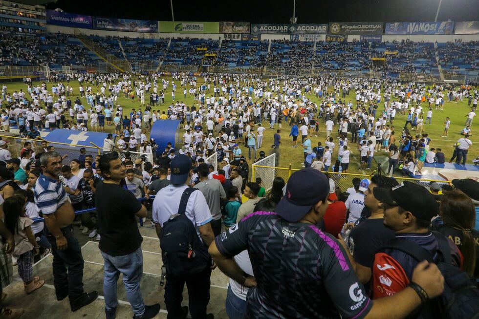 Fans take to the field of Cuscatlan stadium in San Salvador, El Salvador, Saturday, May 20,...