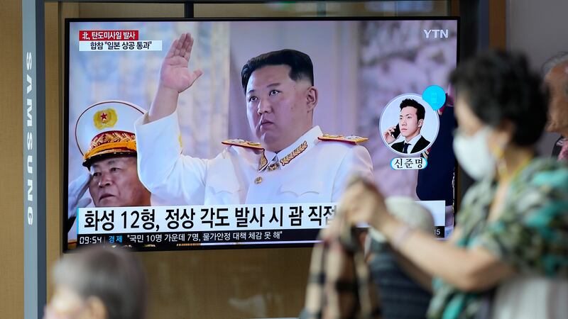 A TV screen showing a news program reporting about North Korea's missile launch with file...