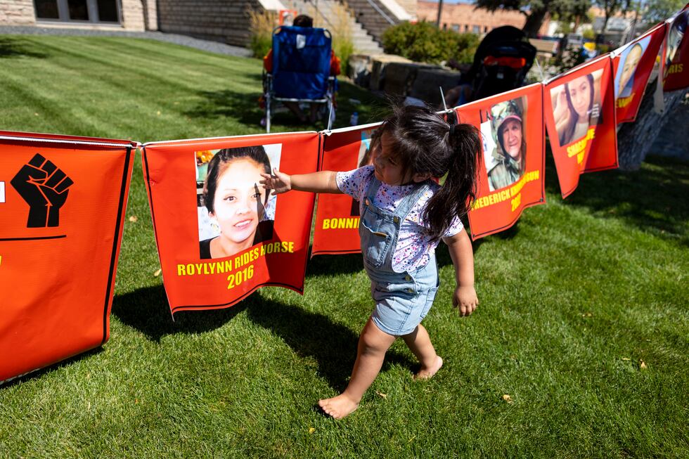 Bernice Old Bull looks at banners hanging during a rally in support of the Missing and...