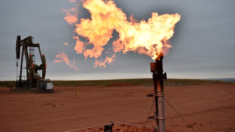 FILE - A flare burns natural gas at an oil well Aug. 26, 2021, in Watford City, N.D.